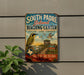 A vintage-style metal sign for the South Padre Island Birding Center, featuring a bird illustration and text promoting the center's offerings.