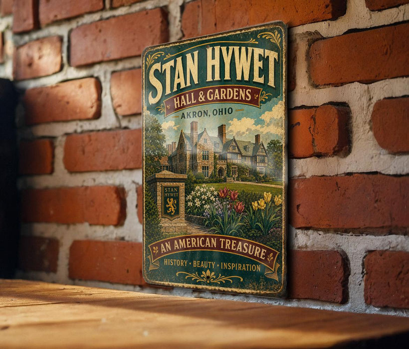 A vintage-style sign for "Stan Hywet Hall & Gardens" in Akron, Ohio, featuring a brick wall and a garden scene.