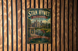 A vintage metal sign for "Stan Hywet Hall & Gardens" in Arron, Ohio, featuring a large illustration of a house surrounded by gardens.