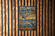 A vintage-style metal sign for the Stillwater National Wildlife Refuge in Nevada, featuring an illustration of a bird and a landscape with mountains in the background.