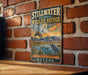 A vintage-style metal sign for Stillwater National Wildlife Refuge in Nevada, featuring an illustration of a bird and a landscape with mountains in the background.