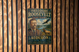 A vintage-style metal sign featuring a portrait of Theodore Roosevelt, the 26th President of the United States, and the words "Theodore Roosevelt Sanctuary Audubon New York".