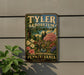 A vintage-style metal sign for " Tyler Arboretum" is displayed on a wall, featuring a scenic landscape with a bridge and trees.