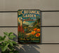 a vintage-style sign for UC Botanical Garden in Berkeley, California, with a tropical garden scene and a tall tower in the background.