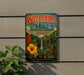 A vintage-style metal sign for Waimea Valley Botanical Garden in Hawaii, featuring colorful illustrations of tropical plants, flowers, and a waterfall.