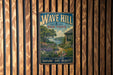 A vintage metal sign for Wave Hill, New York, featuring a scenic landscape with a garden and a house, is displayed on a wooden wall.