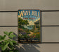 A vintage-style metal sign for "Wave Hill New York" is displayed on a wall, featuring a scenic garden landscape with a house and flowers.