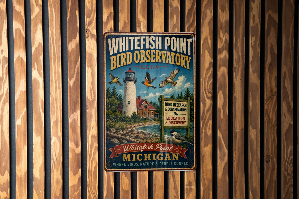 A vintage-style metal sign for the Whitefish Point Bird Observatory in Michigan, featuring a lighthouse and birds in flight.