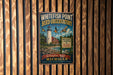 A vintage-style metal sign for the Whitefish Point Bird Observatory in Michigan, featuring a lighthouse and birds in flight.