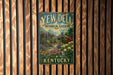 A vintage-style metal sign for Yew Dell Botanical Gardens in Kentucky, featuring a garden scene with a gazebo and flowers.