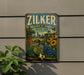 A vintage-style metal sign for the Zilker Botanical Garden in Austin, Texas, featuring a colorful illustration of a garden with flowers, plants, and a bridge.