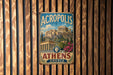 A vintage metal sign displaying the Acropolis of Athens, Greece, with a classical architectural image of the Parthenon.