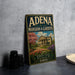 A vintage-style sign for "Adena mansion & gardens" is displayed on a table, featuring a large illustration of a mansion surrounded by a garden with flowers.