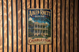 A vintage-style metal sign for the Aiken-Rhetts House in Charleston, South Carolina, featuring a large illustration of the historic building surrounded by palm trees.