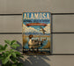A vintage-style sign for the Alamo National Wildlife Refuge in Colorado, featuring a duck and other wildlife in a scenic landscape.