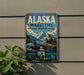 A vintage metal sign for Alaska's Maritime National Wildlife Refuge, featuring an illustration of a whale, seals, and mountains.