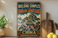 a vintage-style sign advertising the ancient building complex in the Wodang Mountains, China, with a dragon and a temple depicted on the sign.
