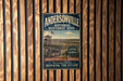 A vintage-style metal sign for the Andersonville National Historic Site in Georgia, featuring an image of a historic fort and a wagon.