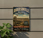 A vintage metal sign for Andersonville National Historic Site, featuring an illustration of a historical fort or structure with a large American flag.