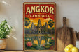 A vintage-style metal sign with the text "ANGKOR CAMBODIA" and an illustration of the Angkor Wat temple complex in Cambodia.