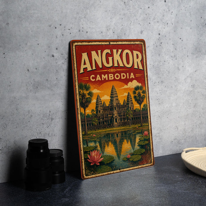 A vintage-style metal sign with the text "ANGKOR CAMBODIA" and an illustration of the Angkor Wat temple complex in Cambodia.