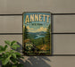 a vintage-style sign for the Annett State Forest in New Hampshire, with a scenic landscape of pine trees, mountains, and a river.