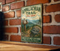 a vintage trail sign for the Appalachian Trail in New York, mounted on a brick wall.
