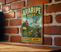 A vintage-style metal sign for Araripe Park in Brazil, featuring a bird and a desert landscape, is hanging on a brick wall.