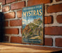 a vintage-style metal sign with a picture of an ancient Greek temple, mounted on a brick wall.