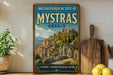 a vintage-style metal sign with a painting of an ancient Greek temple, placed on a wooden shelf next to a potted plant and a wooden cutting board.