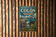A vintage metal sign with the text "ARCHIPIELAGO DE COLON (GALAPAGOS)" and "RESERVA DE BIOSFERA" is displayed on a wooden wall.