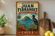 A vintage-style sign for Juan Fernández's reserve in Chile, featuring a tropical landscape with a bird and flowers.