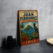 A vintage-style metal sign for Juan Fernández's reserve in Chile, featuring a tropical island landscape with a bird perched on a rock.
