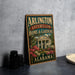 A vintage metal sign for "Arlington Antebellum Home & Gardens" in Alabama, featuring a house surrounded by flowers and greenery.