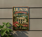A vintage-style sign for "Arlington Antebellum Home & Gardens" in Alabama, featuring a large house surrounded by colorful flowers.