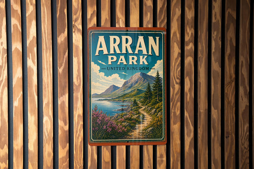 A vintage-style sign for Arran Park, United Kingdom, featuring a scenic mountain landscape with a winding path and a body of water.