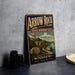 A vintage-style metal sign for the Arrow Rock State Historic Site in Missouri, featuring an illustration of a town and river.