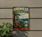 A vintage-style metal sign for Arrowhead Provincial Park, Ontario, featuring a scenic landscape with a lake, mountains, and pine trees.