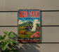 A vintage-style poster advertising Asok Park, Japan, featuring a cow grazing in a mountainous landscape with a steam vent in the background.