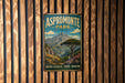 A vintage metal sign for Aspromonte Park in Italy, featuring a scenic mountain landscape with a tree in the foreground.