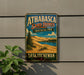 A vintage-style sign for Athabasca Sand Dunes, a scenic park in Saskatchewan, Canada.