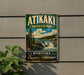 A vintage-style metal sign for Atikaki Provincial Park in Manitoba, Canada, featuring a scenic landscape with a waterfall and pine trees.
