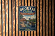 A vintage metal sign for the Augusta Canal in Georgia, featuring a scenic illustration of the canal and surrounding landscape.