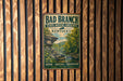 A vintage-style metal sign for Bad Branch State Nature Preserve in Kentucky, featuring a scenic landscape with a river and forest.