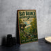 A vintage-style metal sign for Bad Branch State Nature Preserve in Kentucky, featuring a scenic landscape with a river and forest.