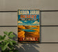 A vintage-style sign for the Badain Jaran Desert in China, featuring a desert landscape with sand dunes and a lake.