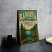 A vintage-style metal sign for Badoura State Forest in Minnesota, featuring a scenic illustration of pine trees and a lake.