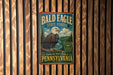 A metal sign with the text "Bald Eagle State Forest" and an illustration of an eagle is displayed on a wooden wall.