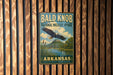A vintage metal sign for Bald Knob National Wildlife Refuge in Arkansas, featuring an eagle in flight and a scenic landscape.