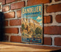 A vintage metal sign for the Bandelier National Monument in New Mexico, featuring a desert landscape with a castle-like structure.
